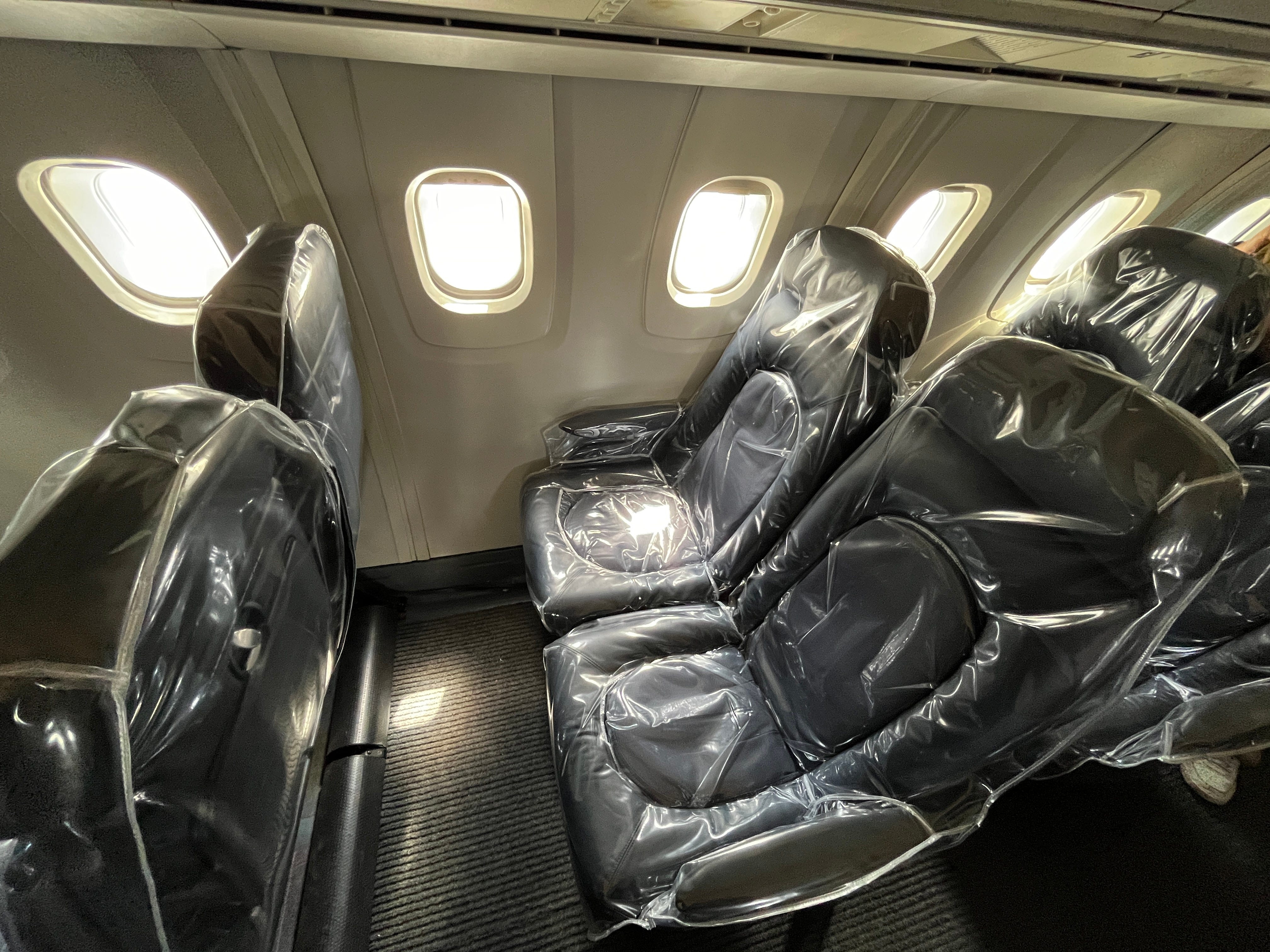 Plastic-covered seats on a plane.