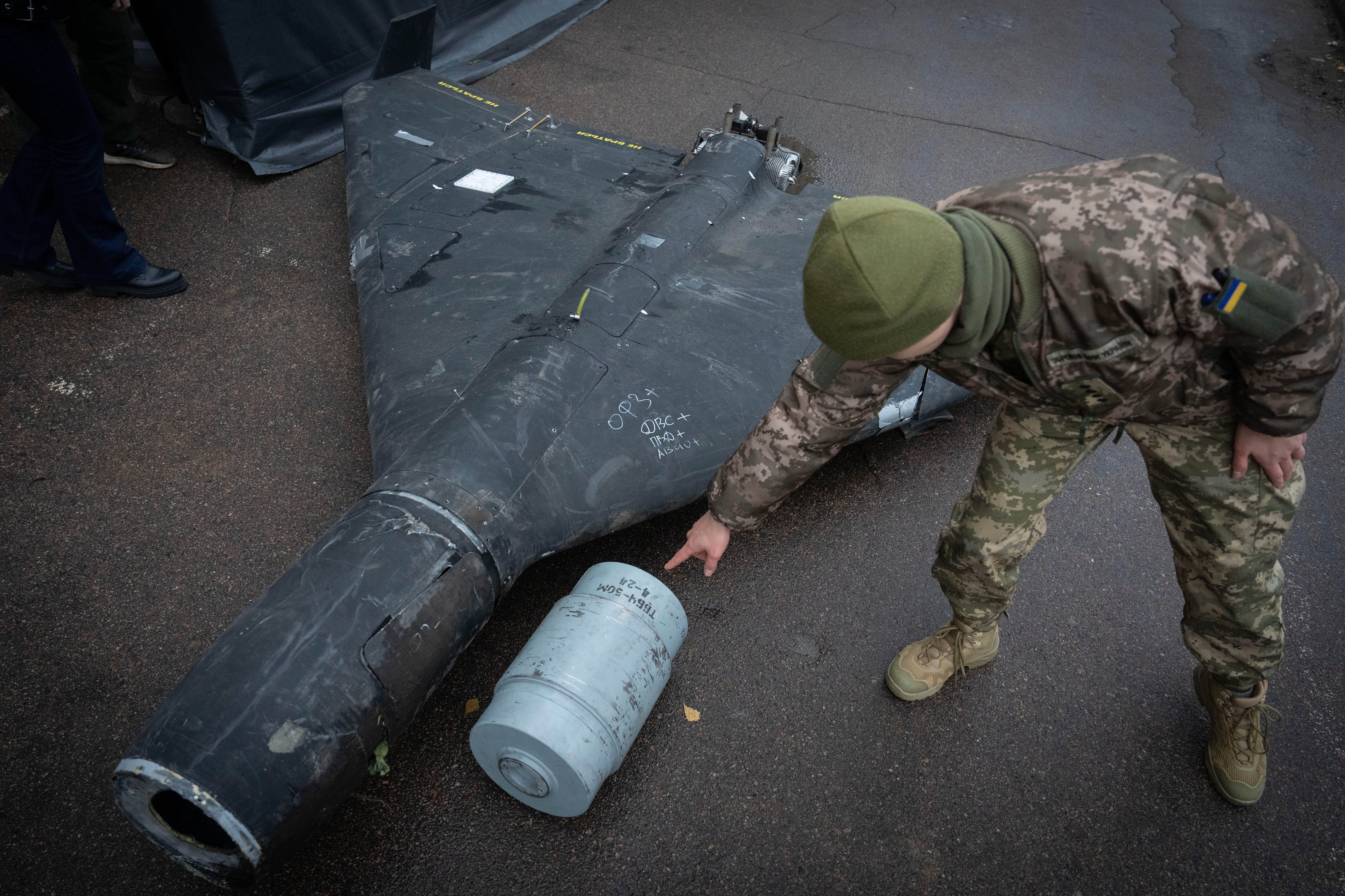 A Ukrainian officer shows a thermobaric charge of a downed Shahed drone at an undisclosed location in Ukraine in November.
