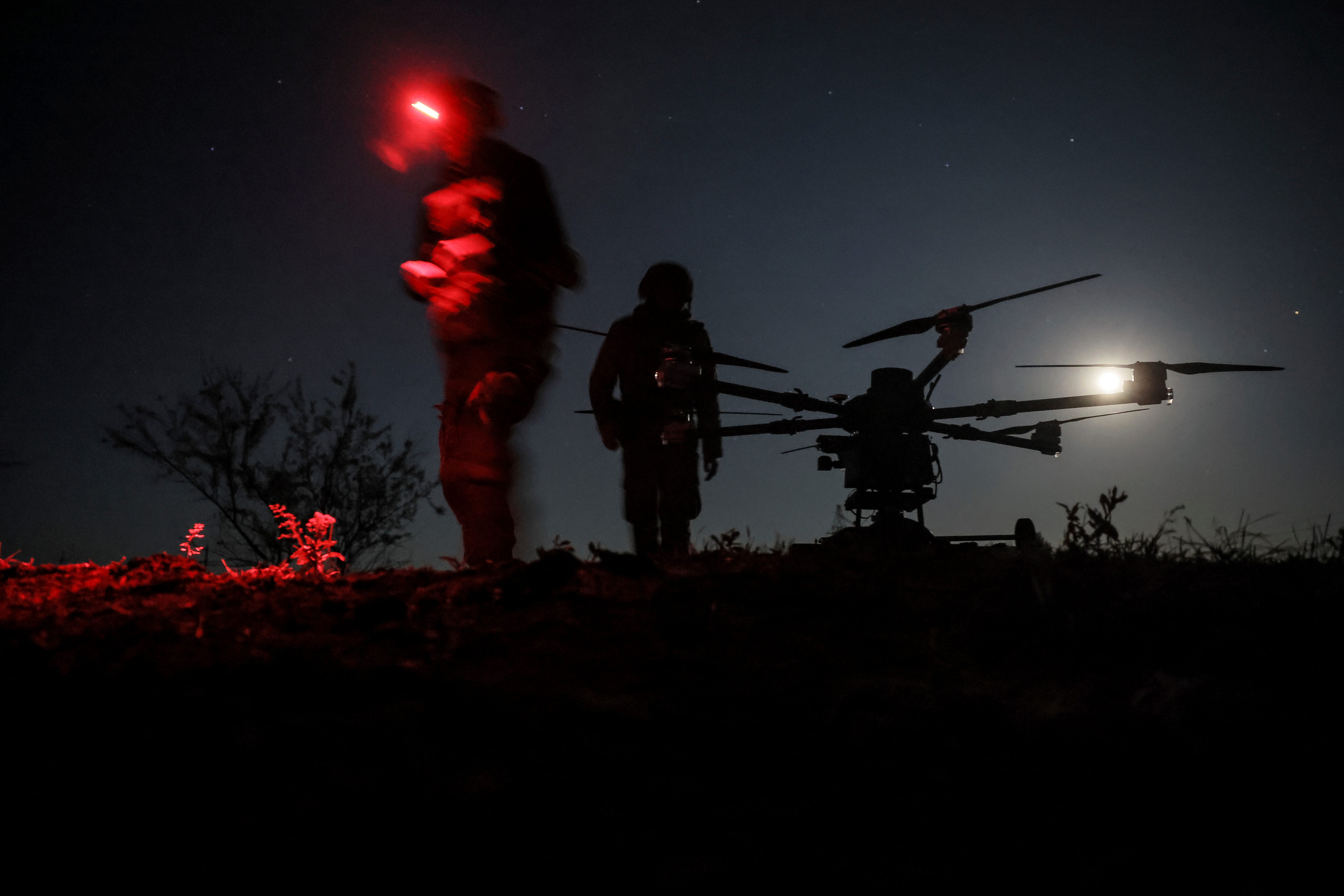 In this photo provided by Ukraine's 24th Mechanized Brigade press service, servicemen prepare the drone 