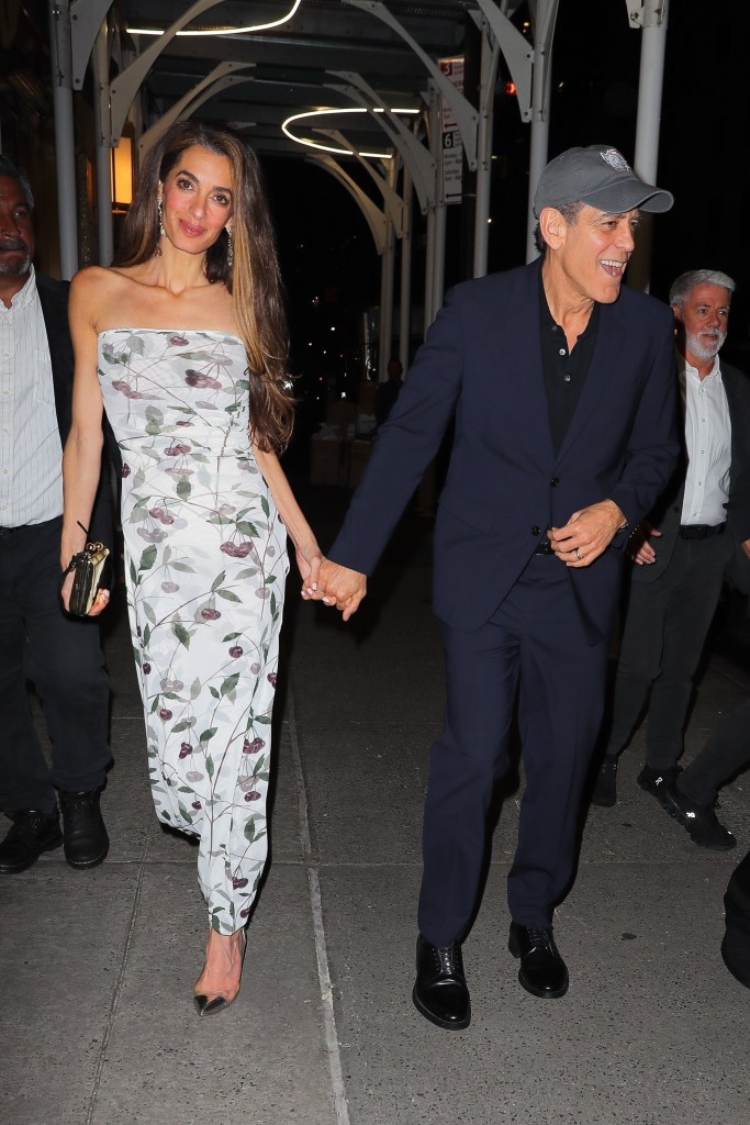 Amal and George Clooney holding hands in New York City