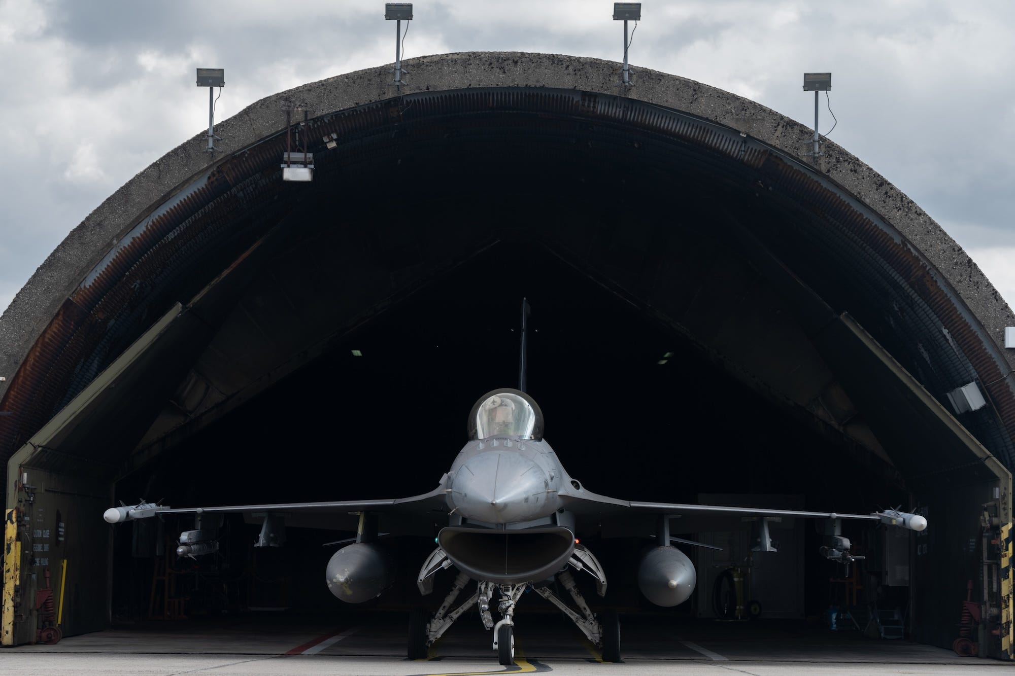 A US F-16 fighter jet sits in a hardened shelter in 2025 at Spangdahlem Air Base, Germany.