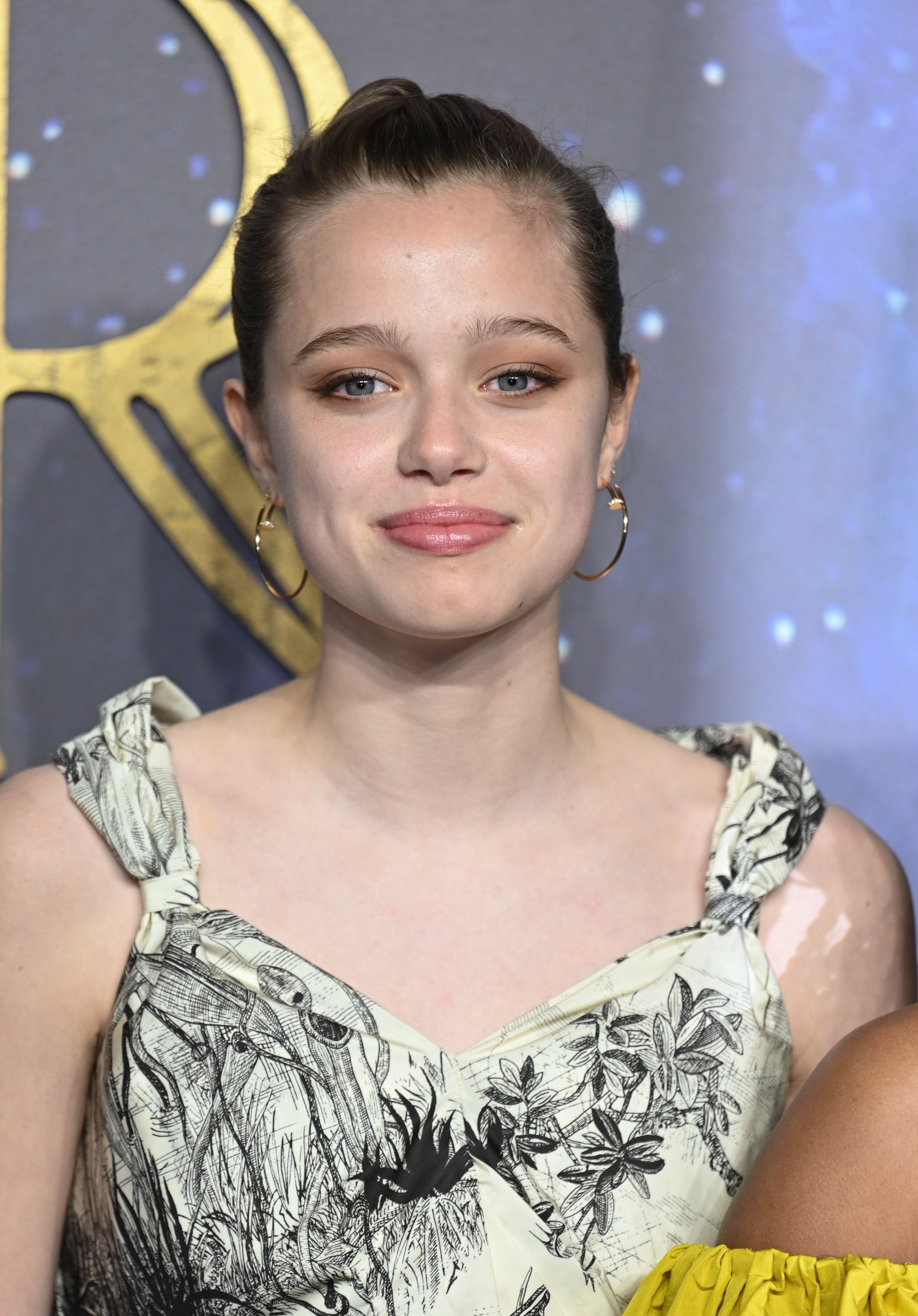 Shiloh Jolie smiles at a formal event. 
