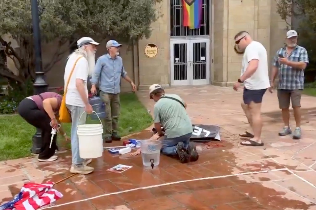 People cleaning up after a molotov cocktail attack at a Run For Their Lives event.