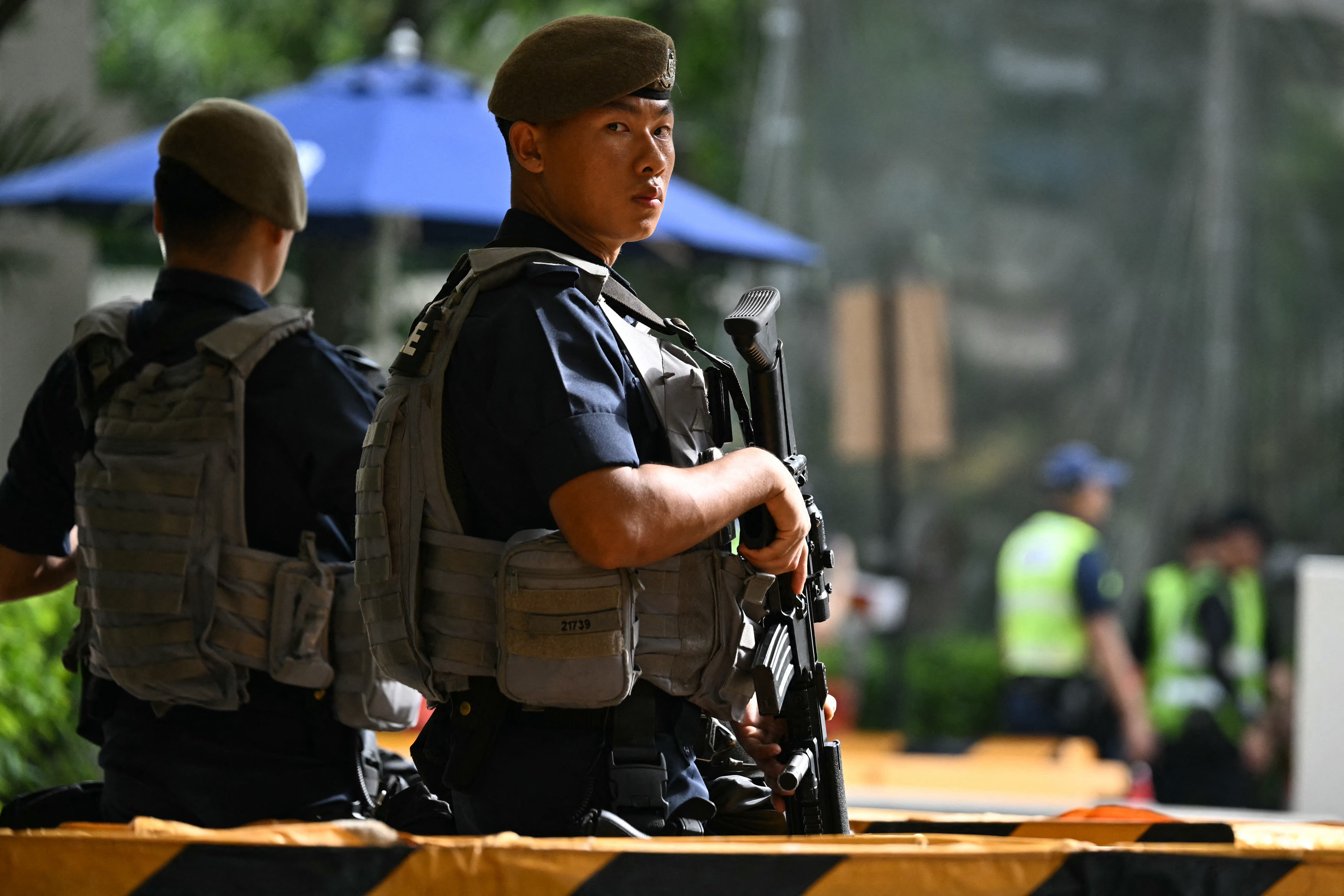 Police officers keep watch at security checkpoints outside the hotel.