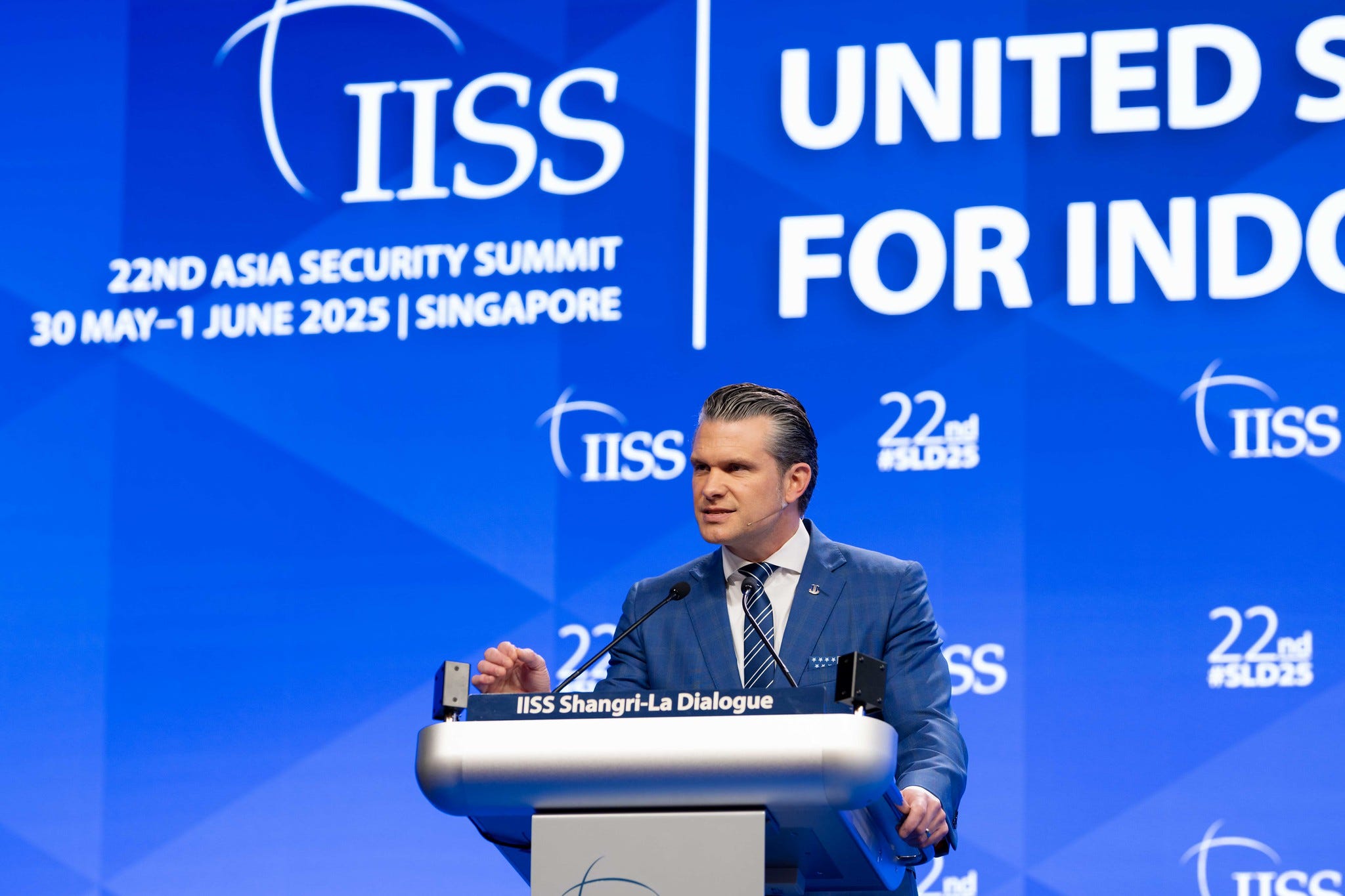 Defense Secretary Pete Hegseth speaks on the podium at the Shangri-La Dialogue.