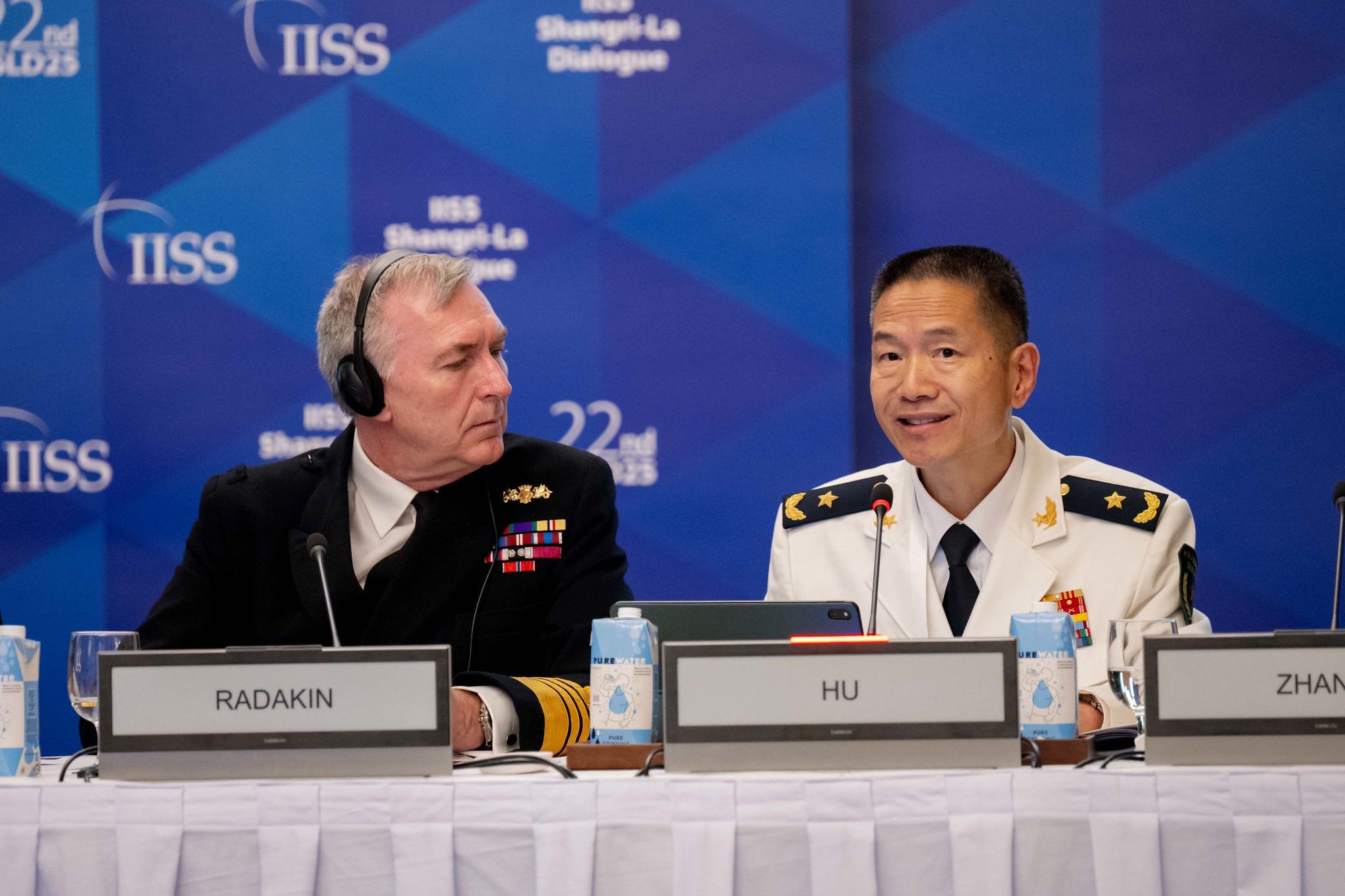 Rear Adm Hu Gangfeng speaks next to Adm. Tony Radakin, the UK's chief of defense staff.