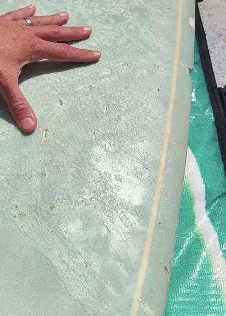 Close-up of a damaged surfboard.