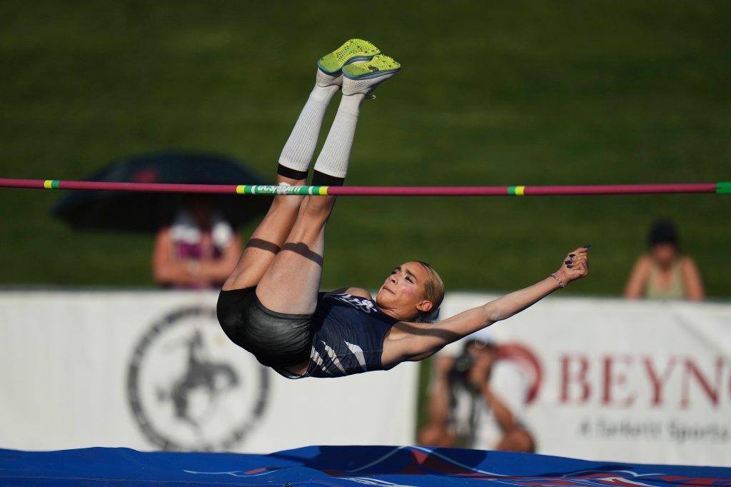 Transgender high school athlete performing a high jump.
