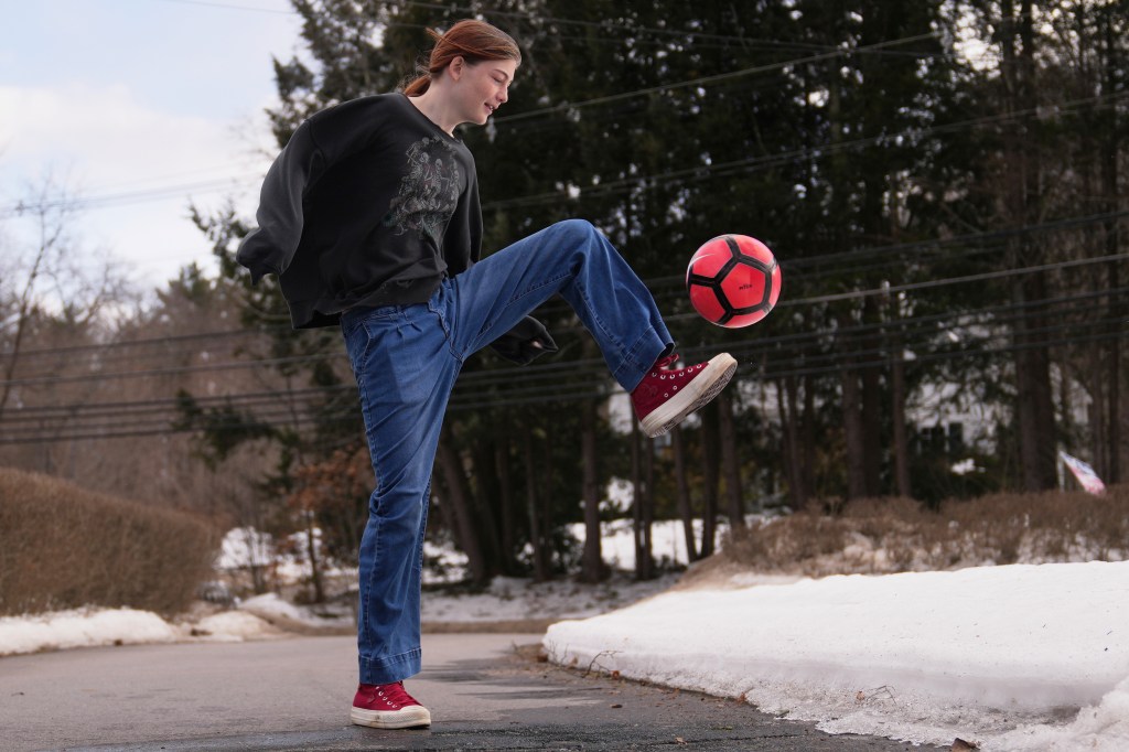 Transgender high school soccer player juggling a soccer ball.