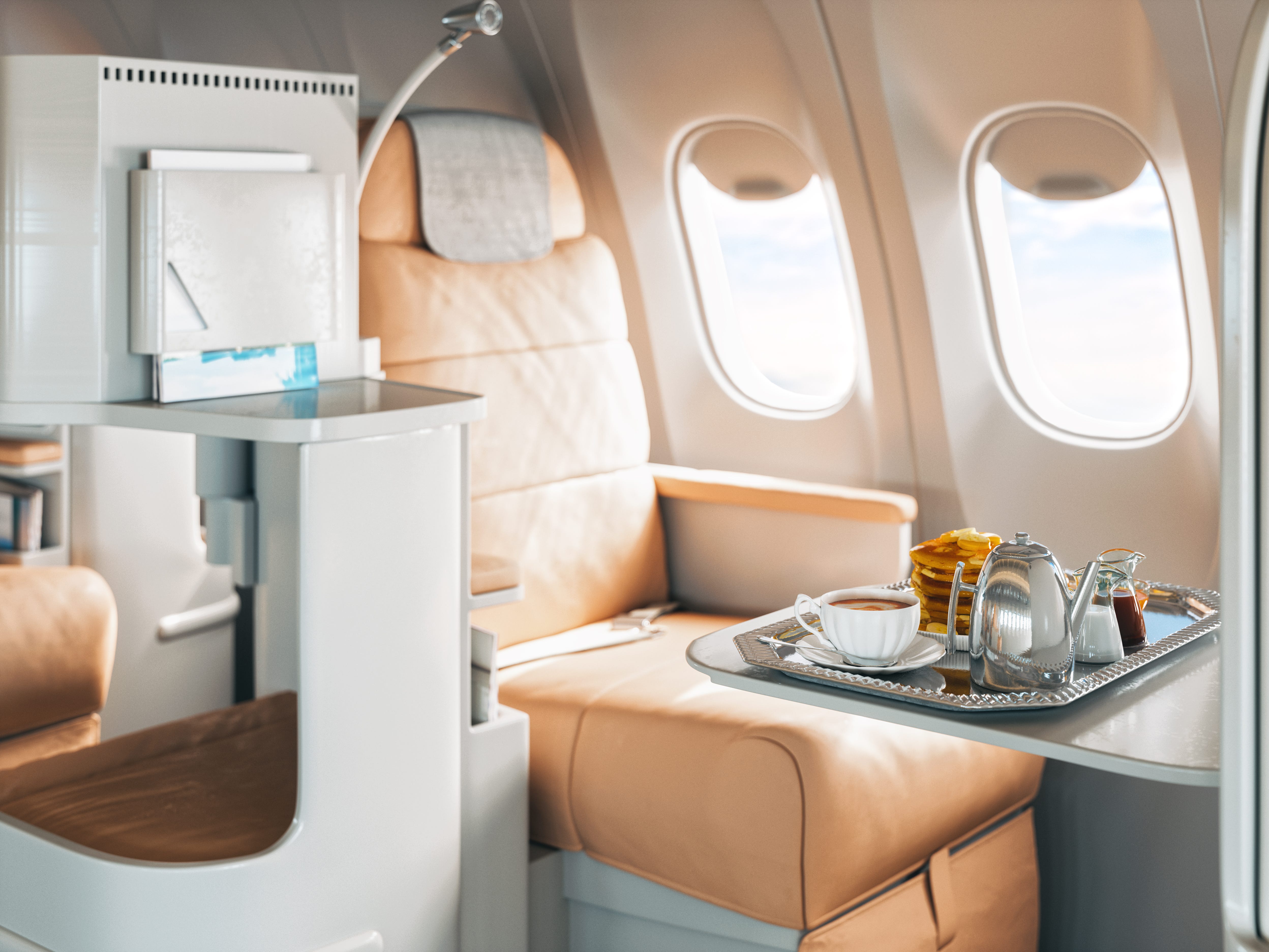 A beige First Class Airplane Seat With Tray Of Food