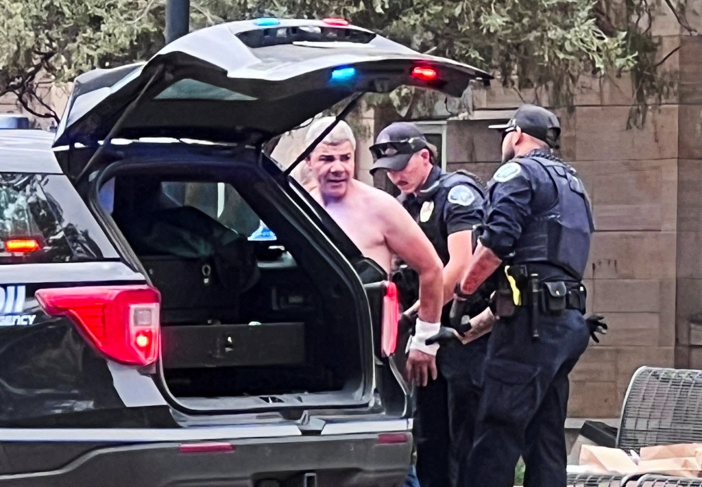 Law enforcement officers detaining a suspect in Boulder.