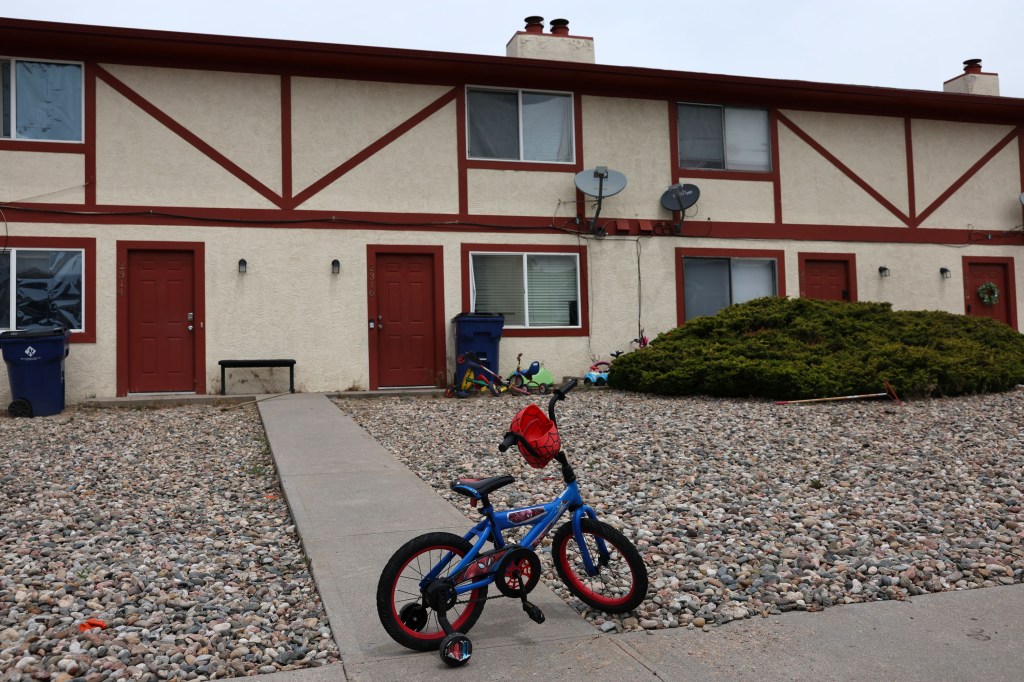 Exterior of Mohamed Soliman's home in Colorado Springs, CO.  A child's bicycle sits in the gravel near the walkway.