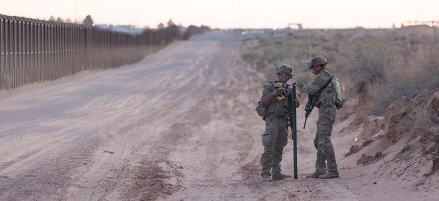 U.S. Army Spc. Jesus Montano and Pfc. Valentino Pappalardi, assigned to 76th Engineer Company, with Joint Task Force–Southern Border, assemble a sign marking the New Mexico National Defense Area near Sunland Park, New Mexico, May 21, 2025.