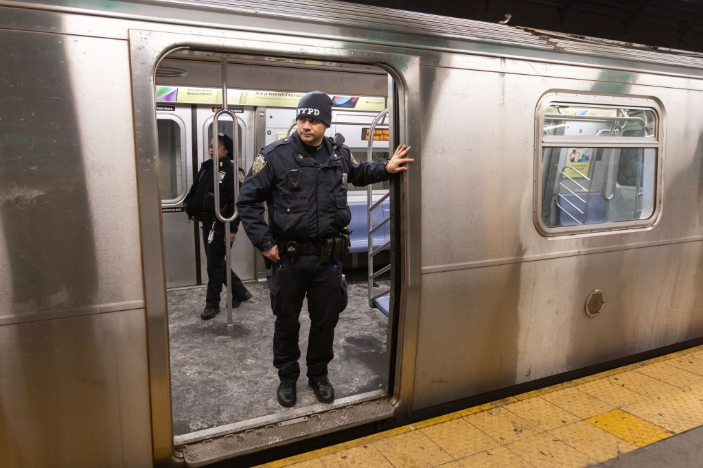 An NYPD officer takes an overnight patrol ride on an L Train on Jan. 21, 2025.