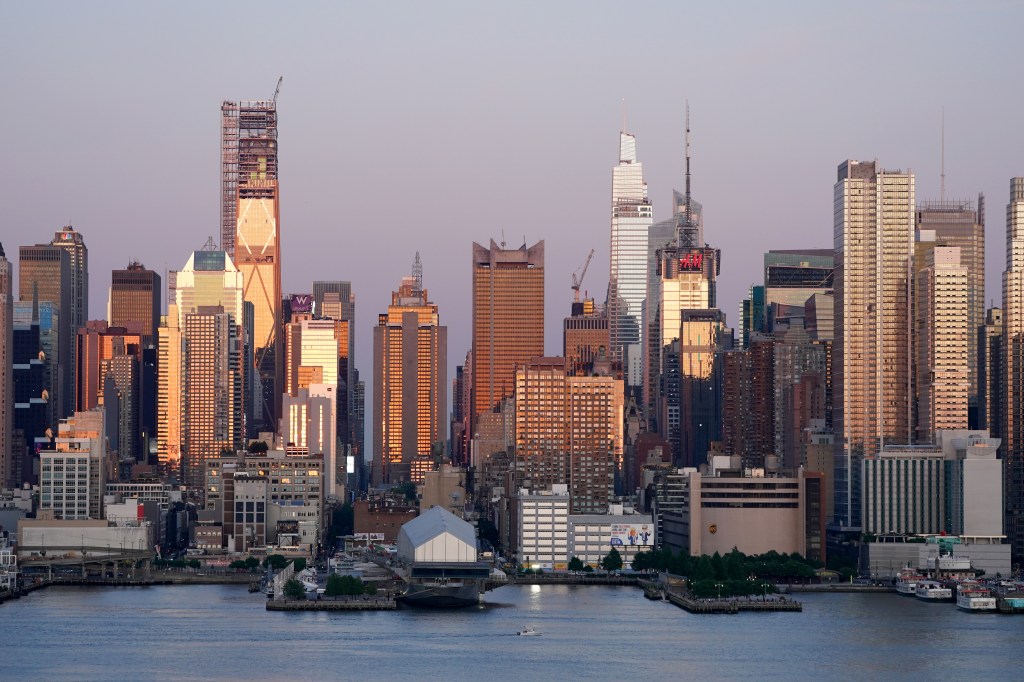 Buildings in Midtown Manhattan shine during the sunset on May 31, 2024.
