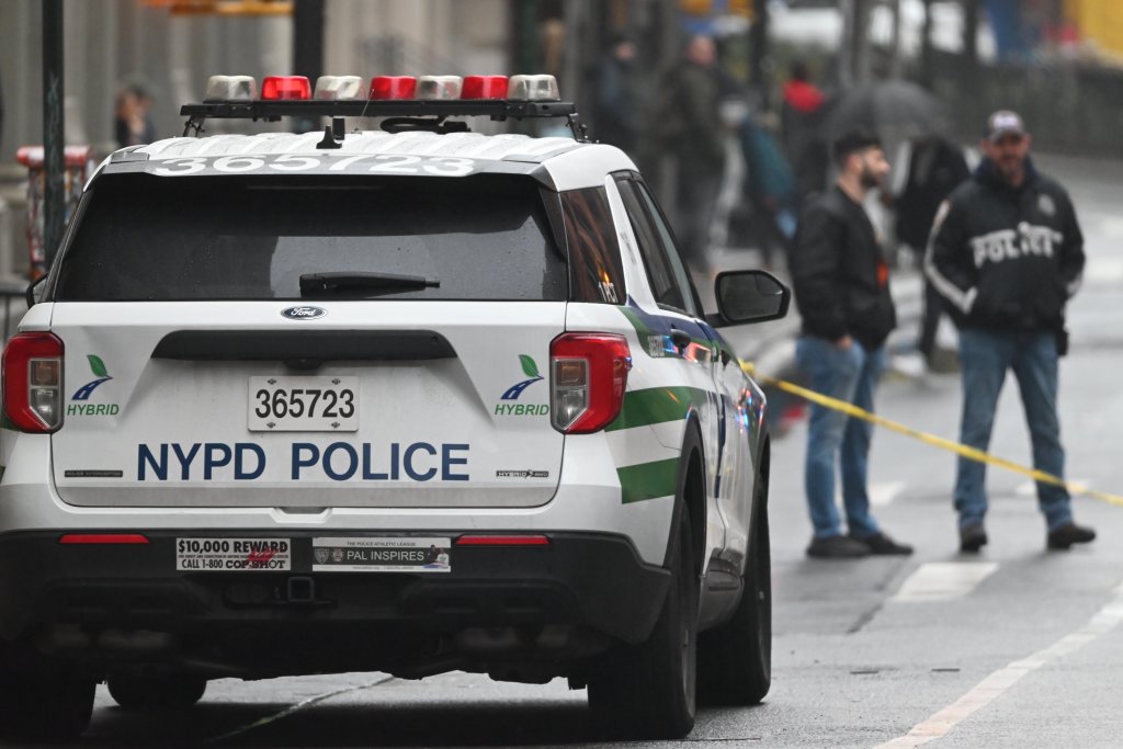 An NYPD patrol car is parked at the scene of a stabbing at Wooster Street and Broome Street in SoHo on April 7, 2025.