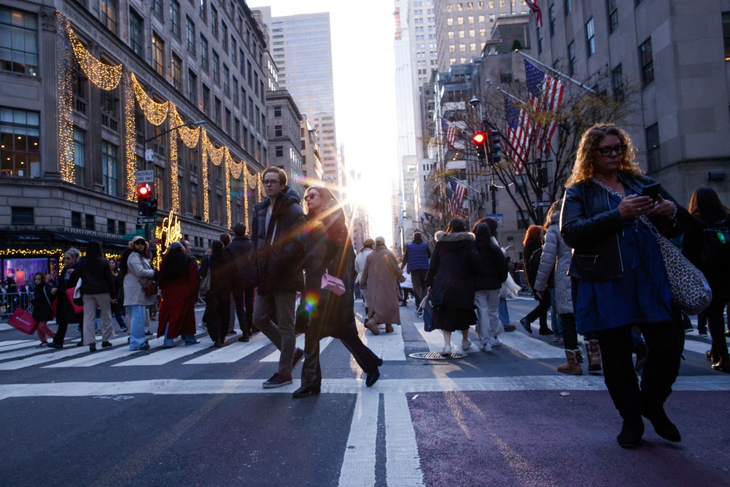 Pedestrians cross Fifth Avenue on Dec. 8, 2024.