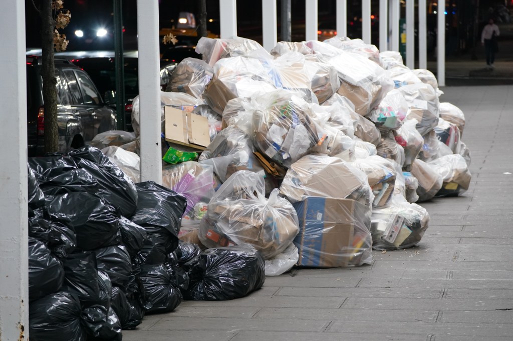 Nearly a hundred bags of garbage pile up at the curb for pickup in NYC on Oct. 5, 2024.