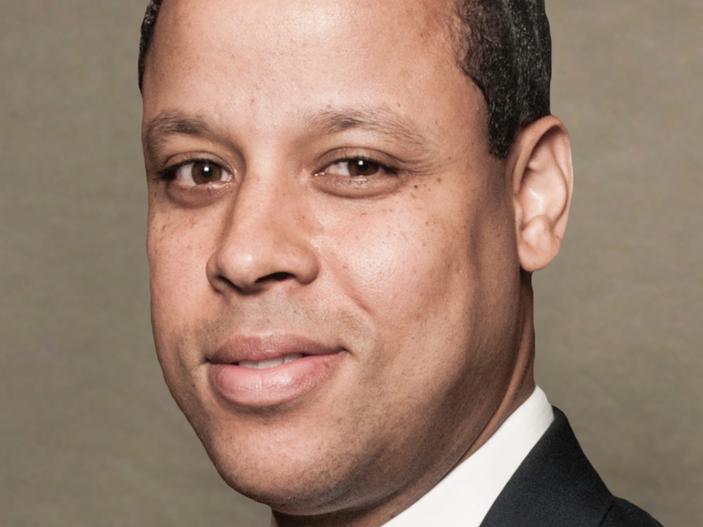 Verdun Perry, Global Head of Blackstone Strategic Partners in a suit.