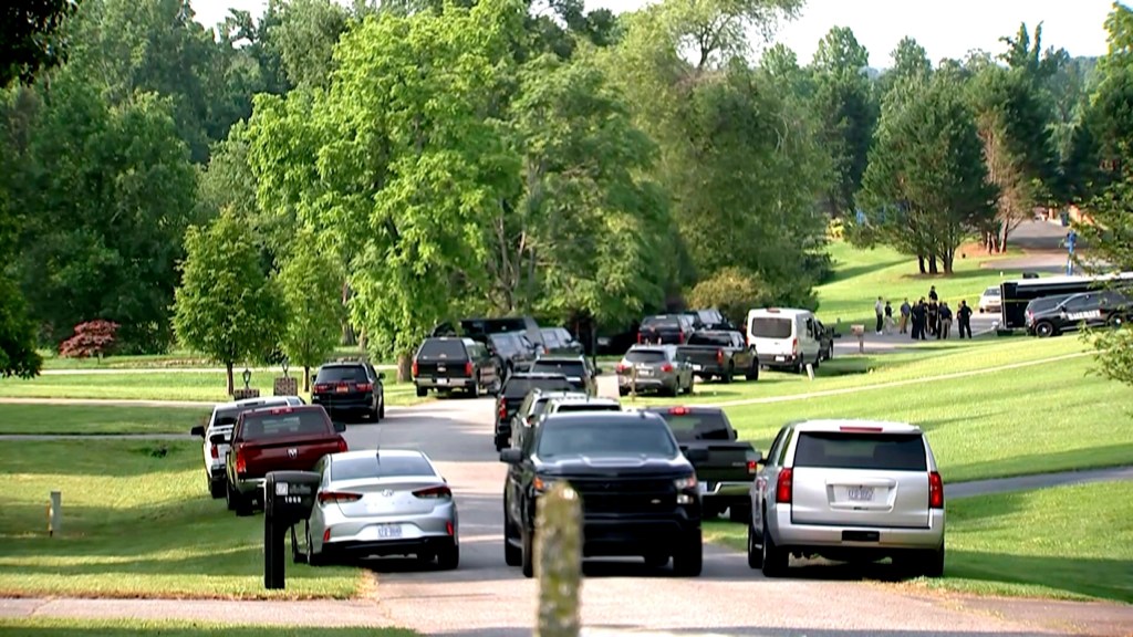 various police vehicles gather outside a community after a mass shooting, Sunday, June 1, 2025, in Hickory