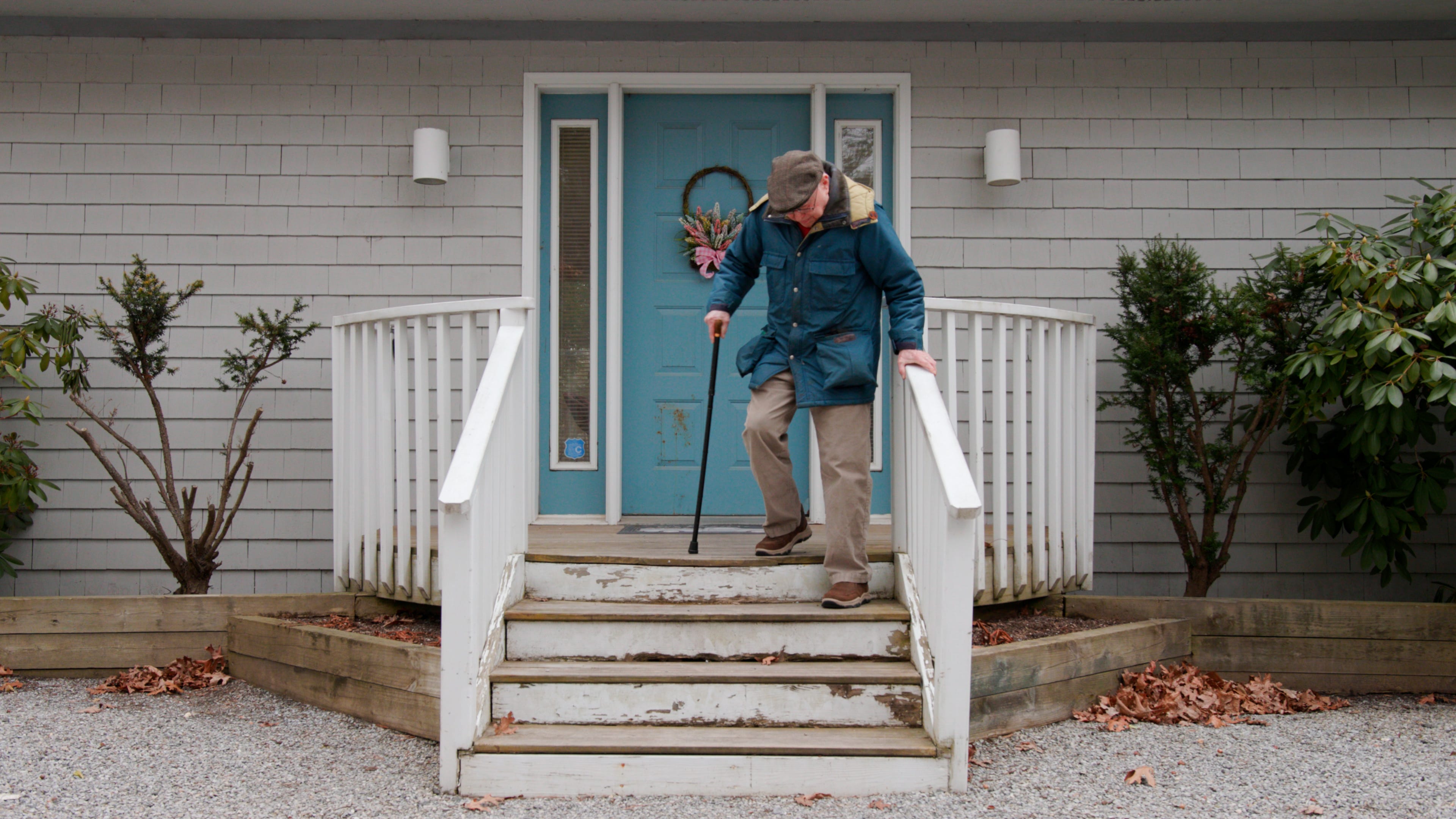 Jack Weber walking down his porch with a cane.
