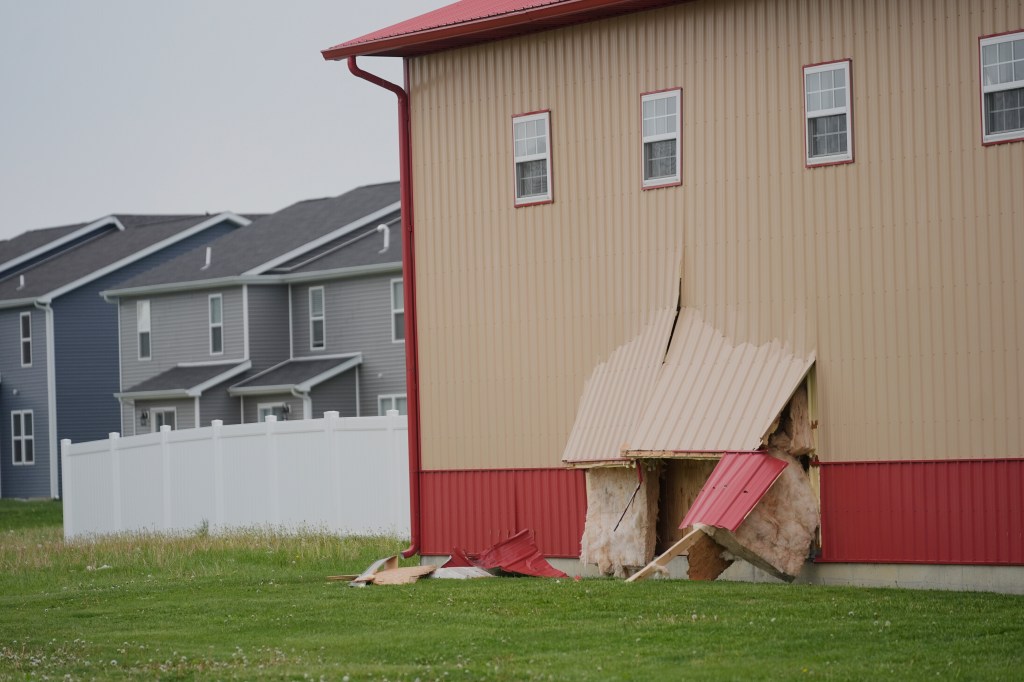 Damage to a building after a car crash.