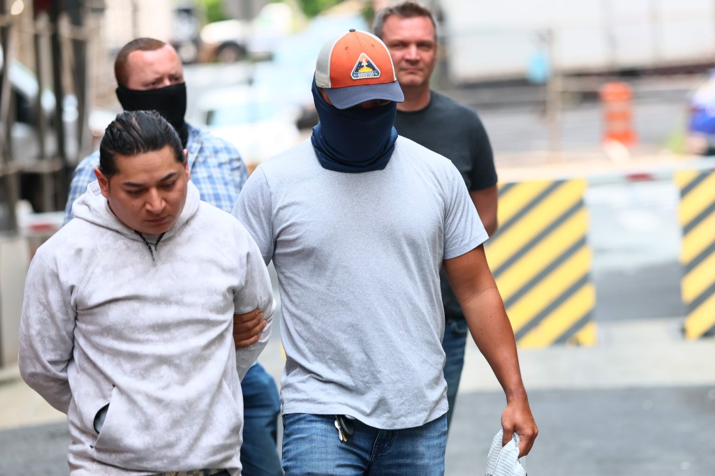 Federal agents escorting detainees after immigration court hearings.