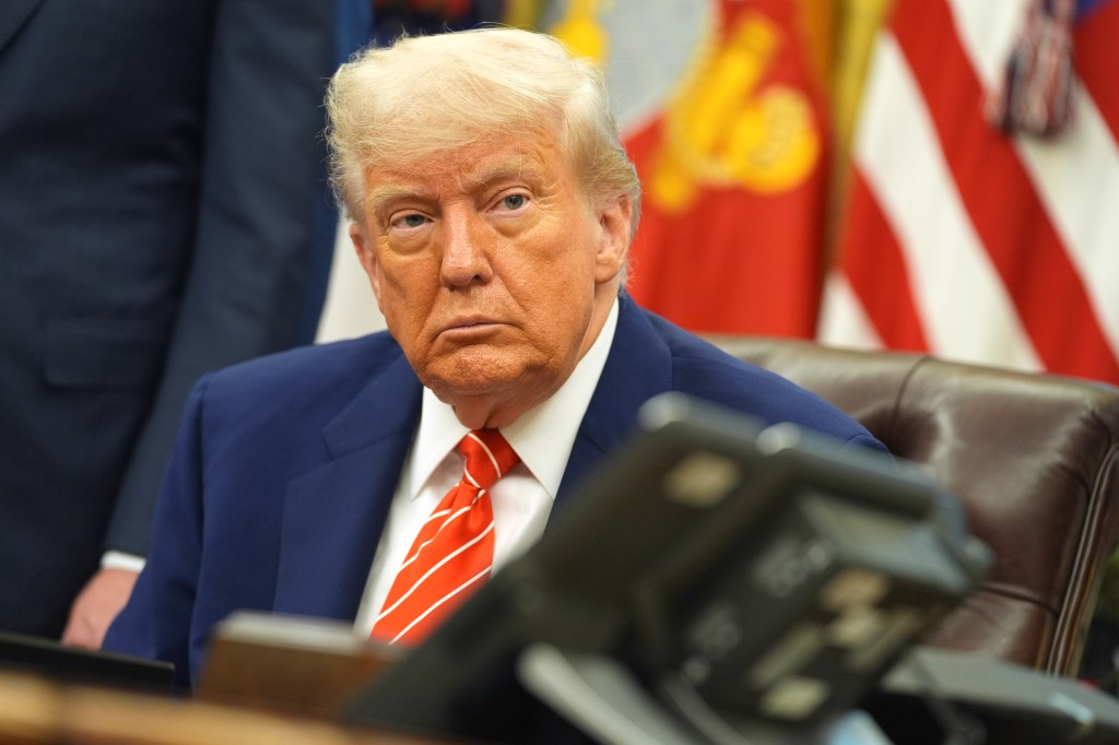 Donald Trump in a blue suit and red tie.