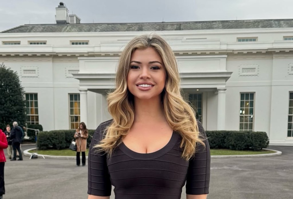 Woman in a black dress in front of the White House.