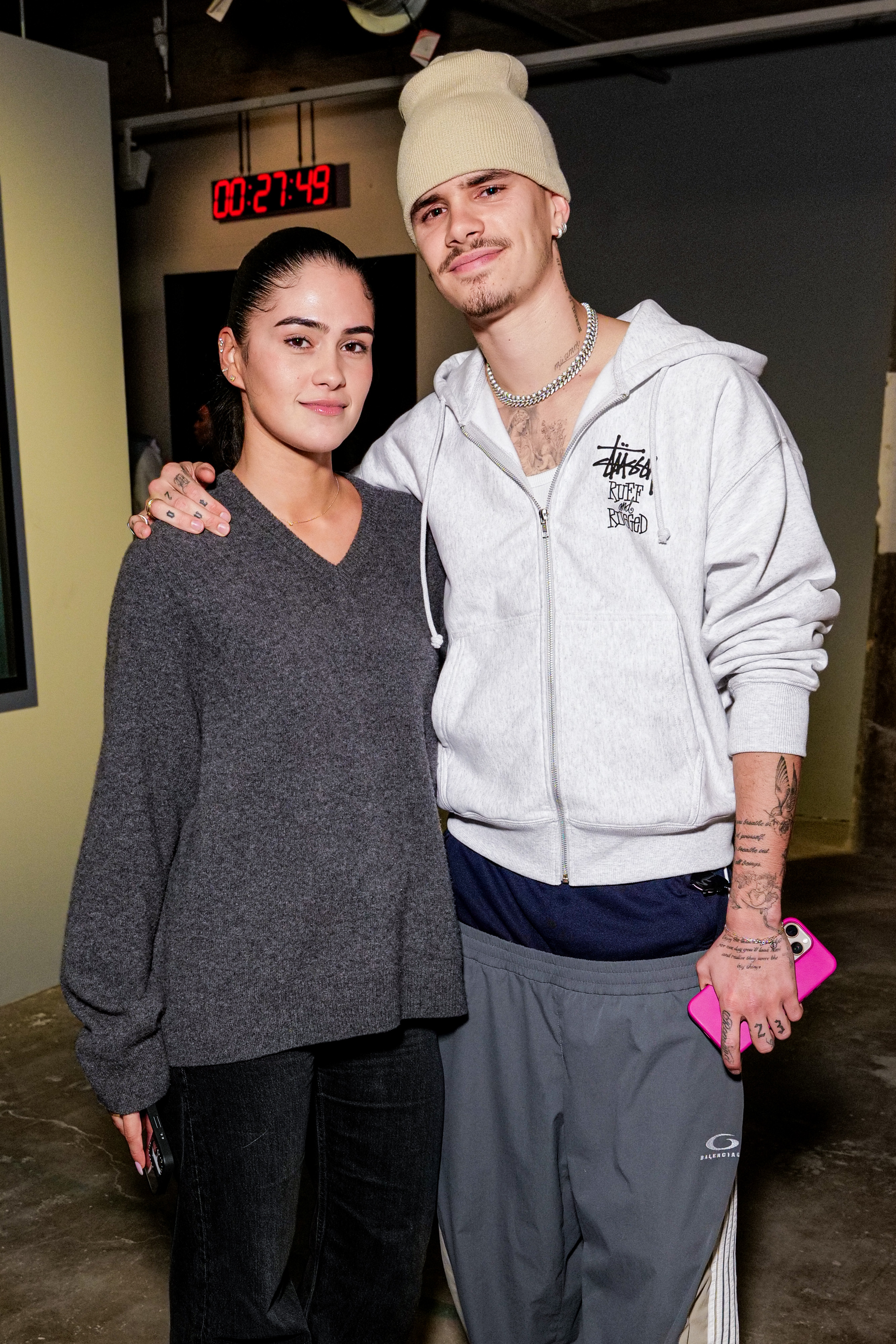 Romeo Beckham and Kim Turnbull at an event. 