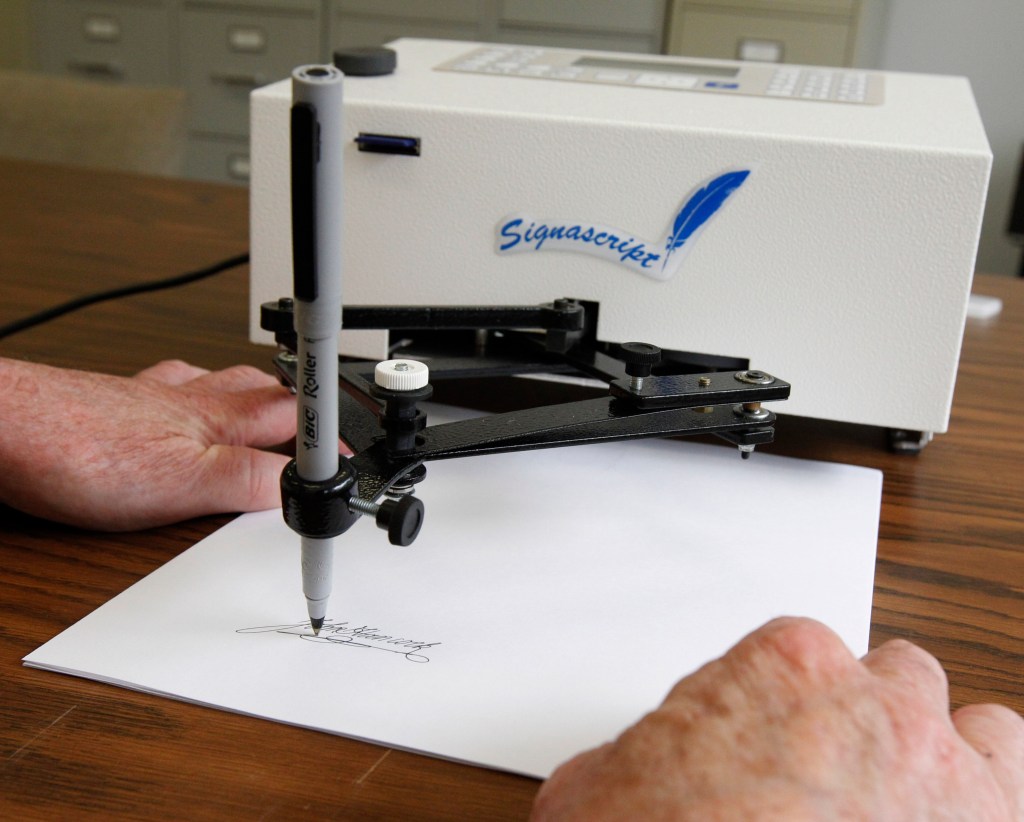 Autopen signing a document.
