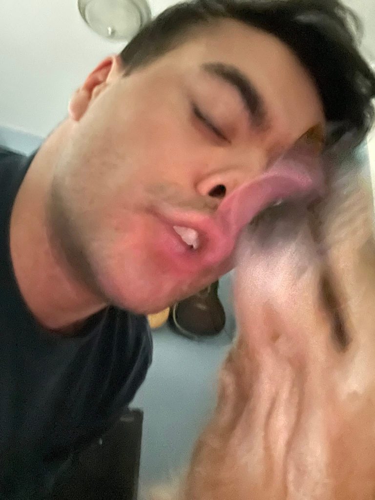 Man kissing a dog.