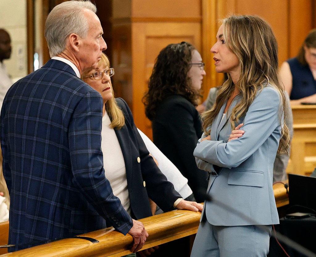 Karen Read speaks with her parents during a court break.