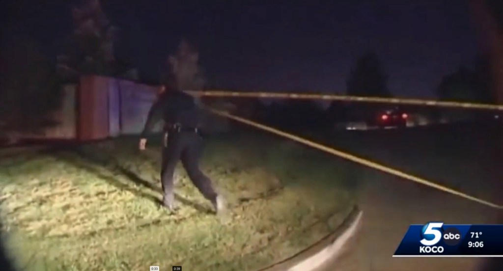 Police officer at a nighttime crime scene.