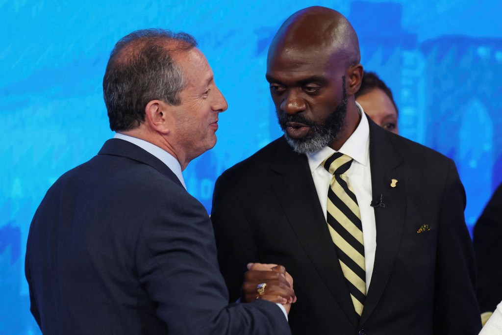 Brad Lander and Michael Blake shakes hands after participating in the debate.
