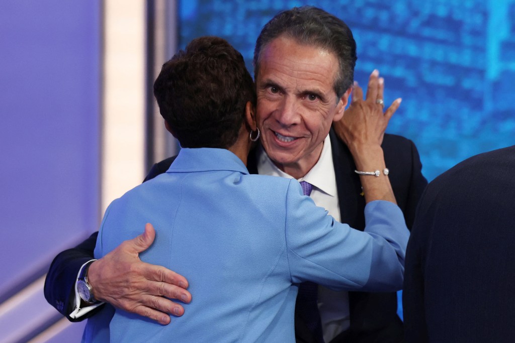 Andrew Cuomo and Adrienne Adams hug onstage after the debate.