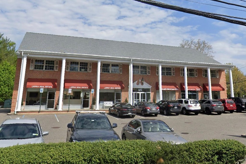 Exterior view of 55 Northern Blvd in Greenvale, NY, a brick building with multiple businesses, including Laffey Real Estate.