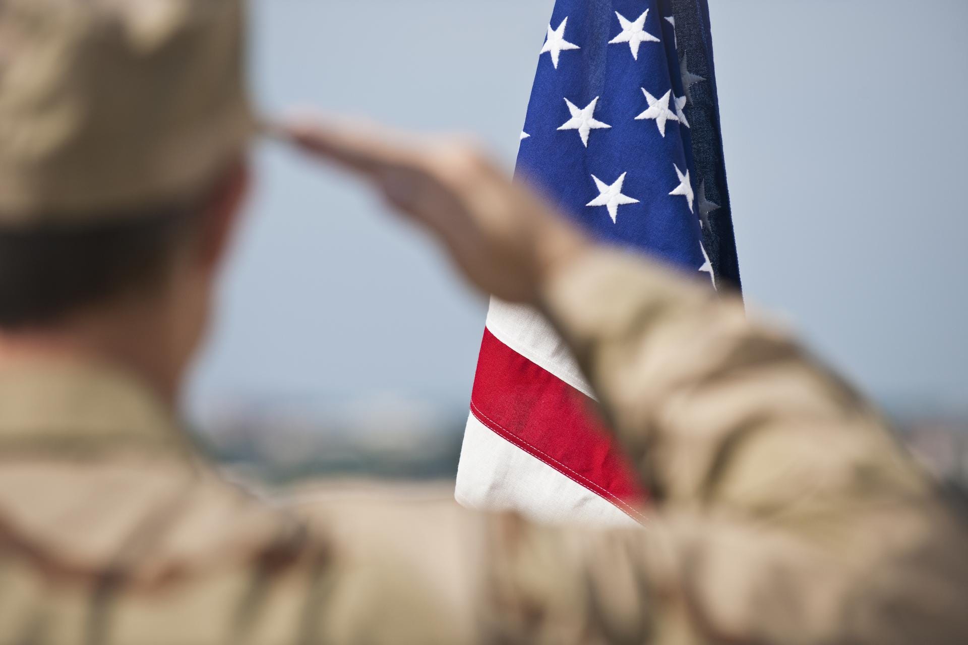 Soldier saluting US flag