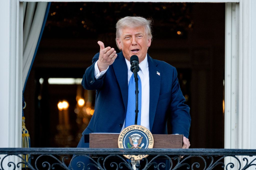 President Trump speaking at a podium on the White House South Lawn.