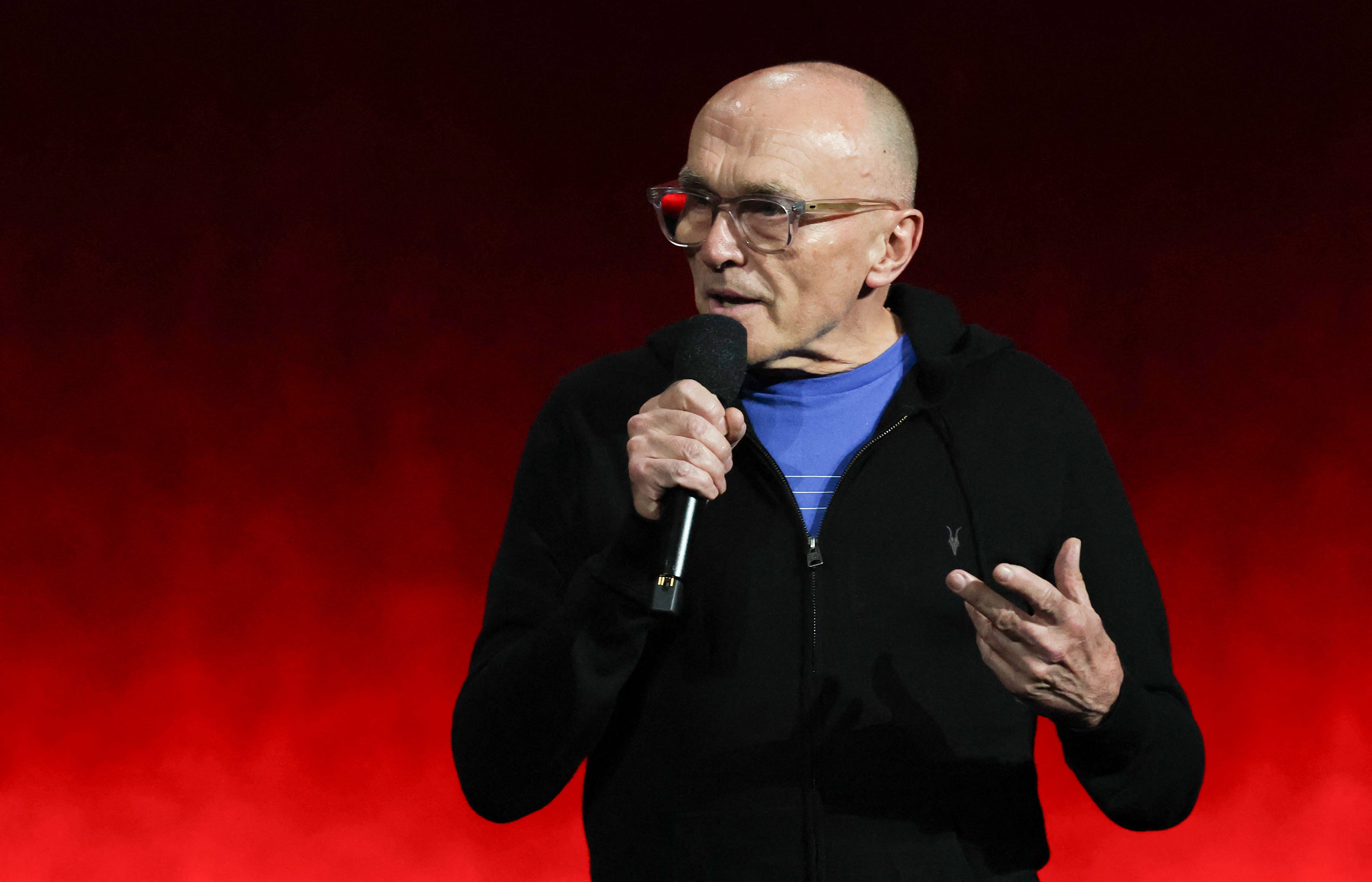 Danny Boyle holding a microphone