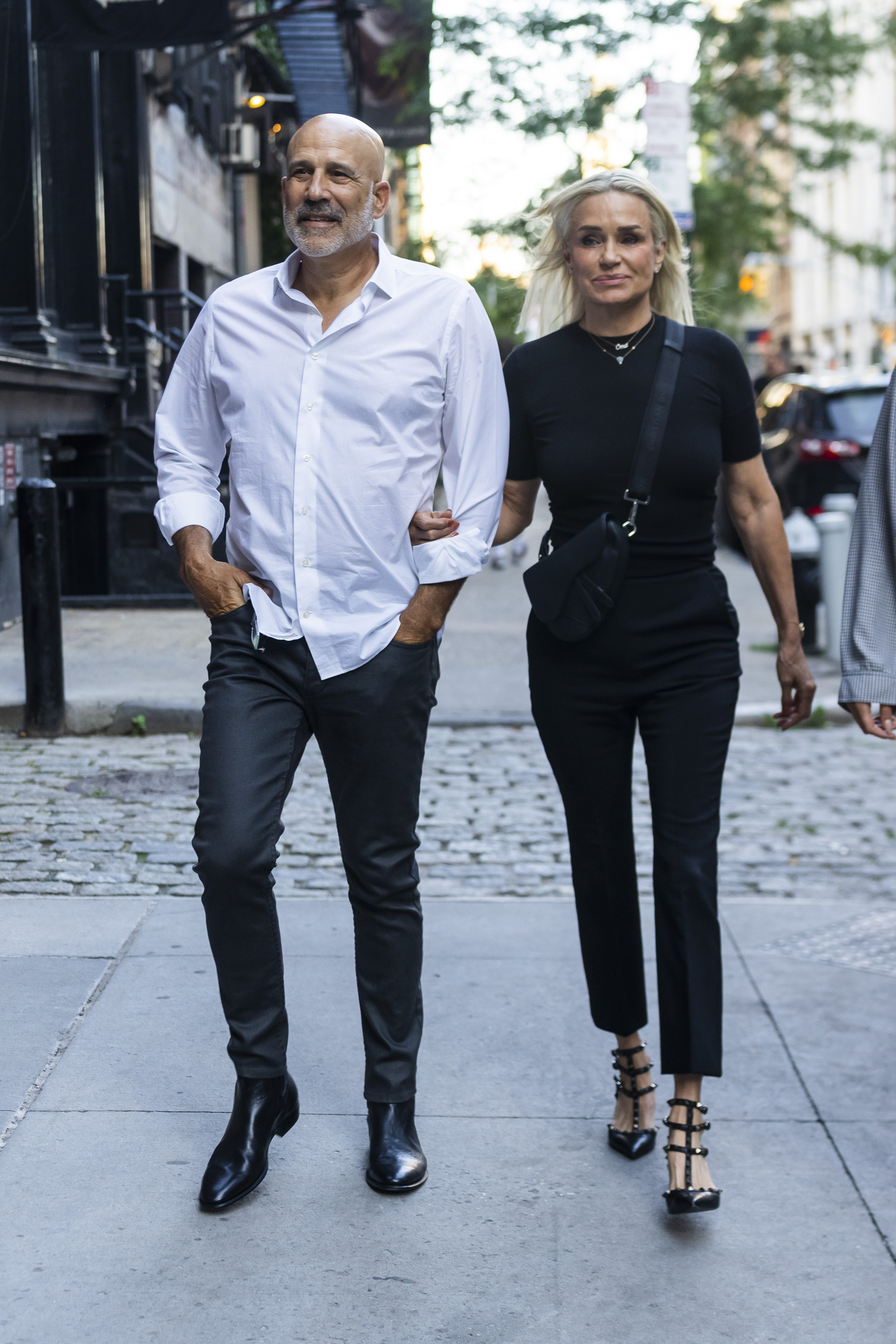 Yolanda Hadid walks outdoors with Joseph Jingoli. 