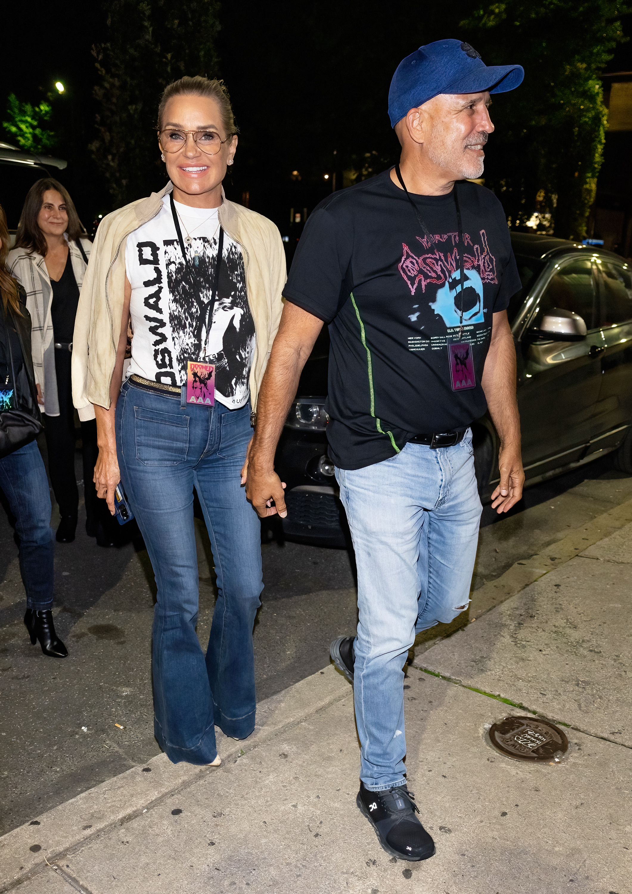 Yolanda Hadid and Joseph Jingoli hold hands while walking.