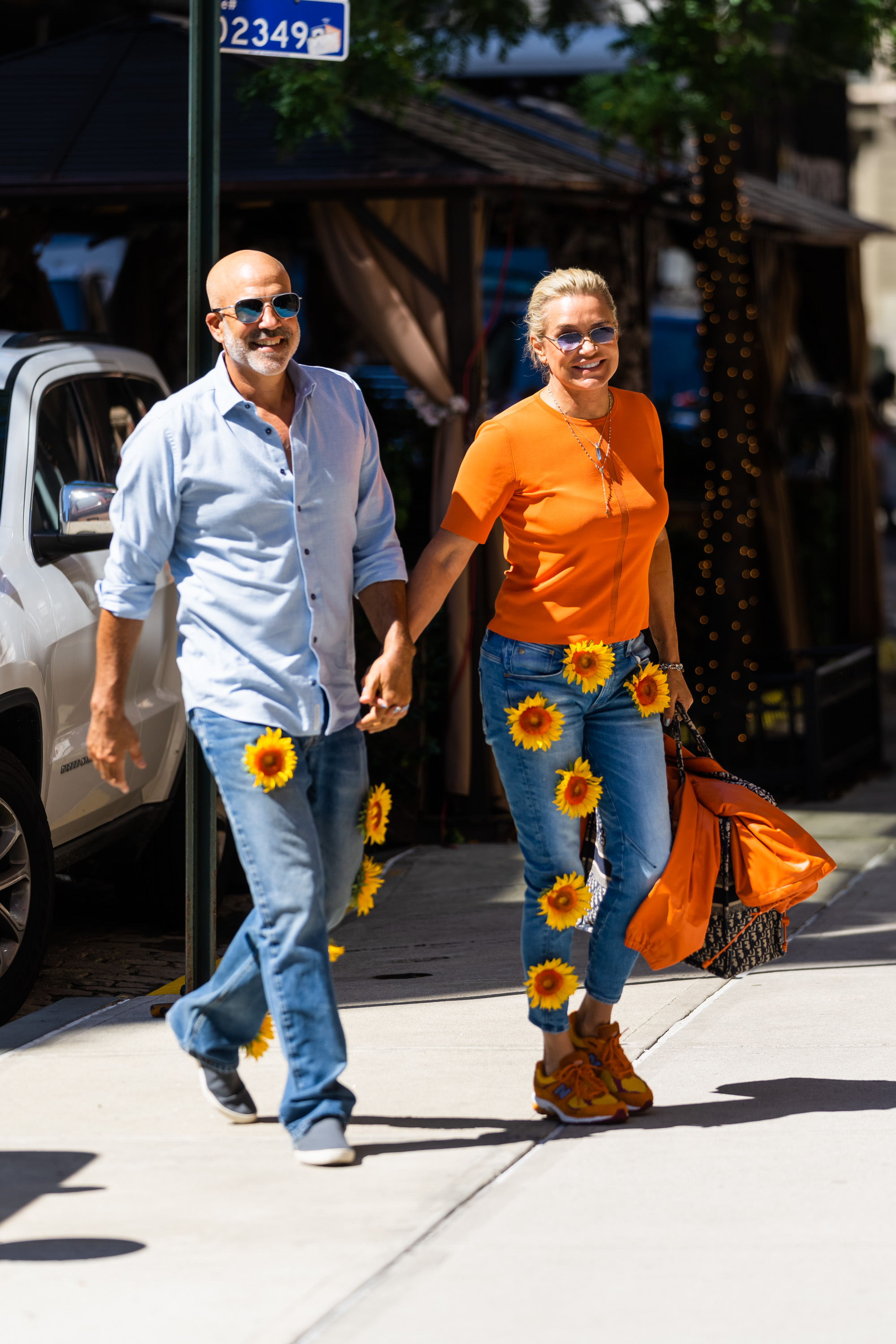 Yolanda Hadid and Joseph Jingoli wear jeans with flowers on them while outdoors. 