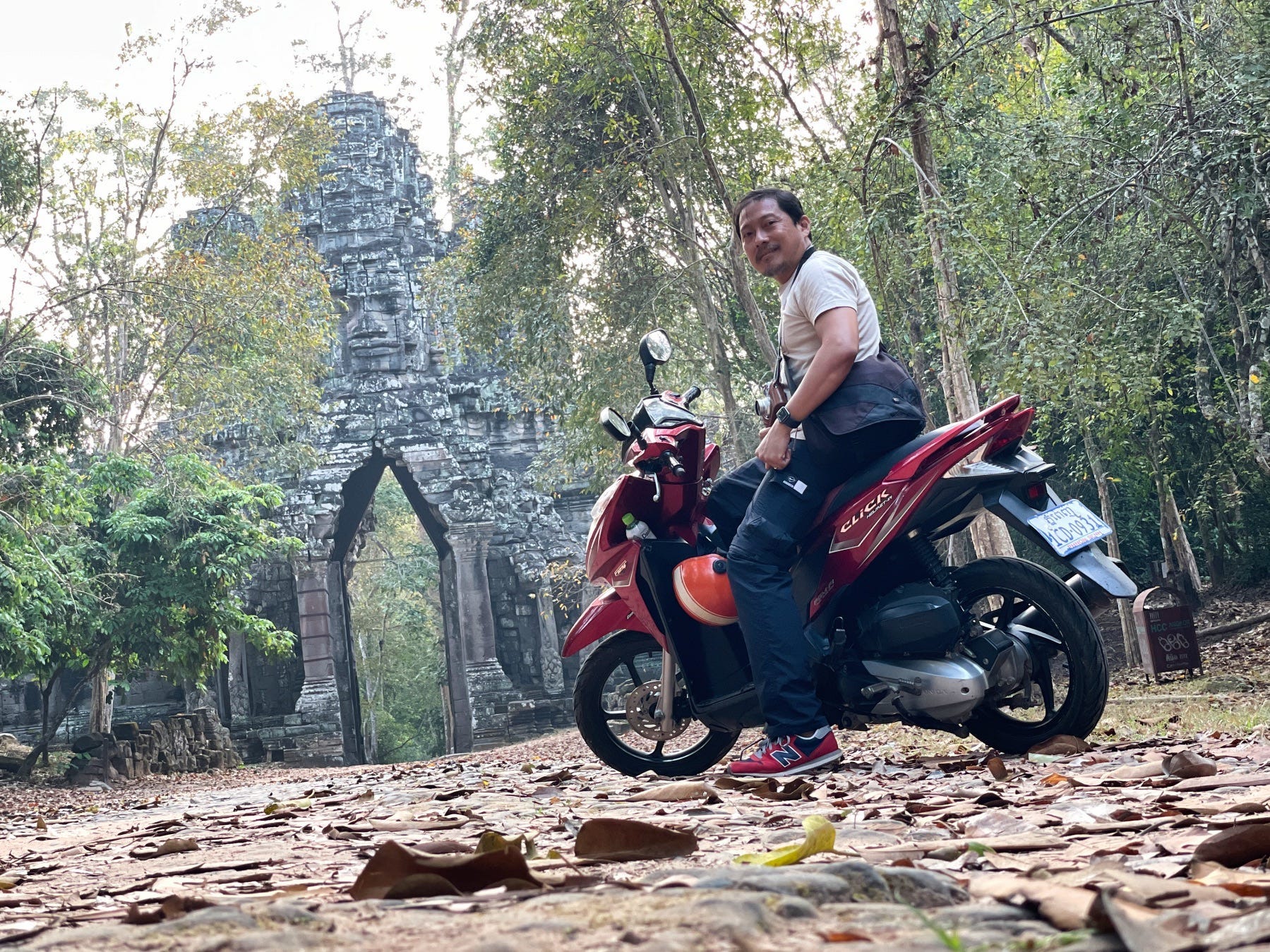 Man on a motorcycle at Angkor Wat in Siem Reap, Cambodia.