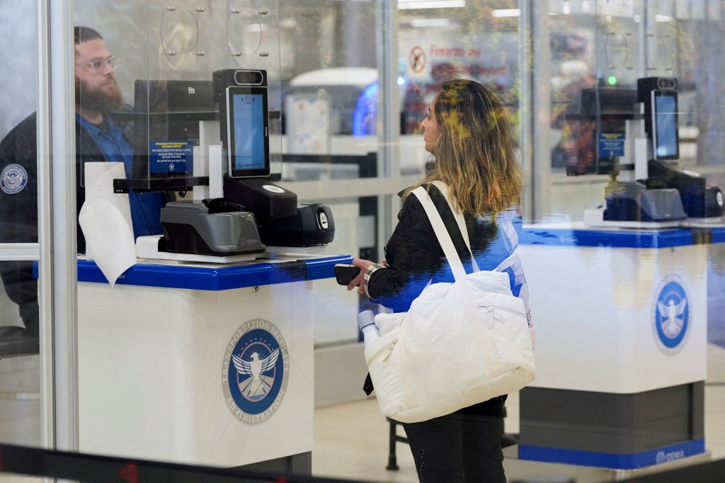 Passenger at TSA checkpoint using facial recognition technology.
