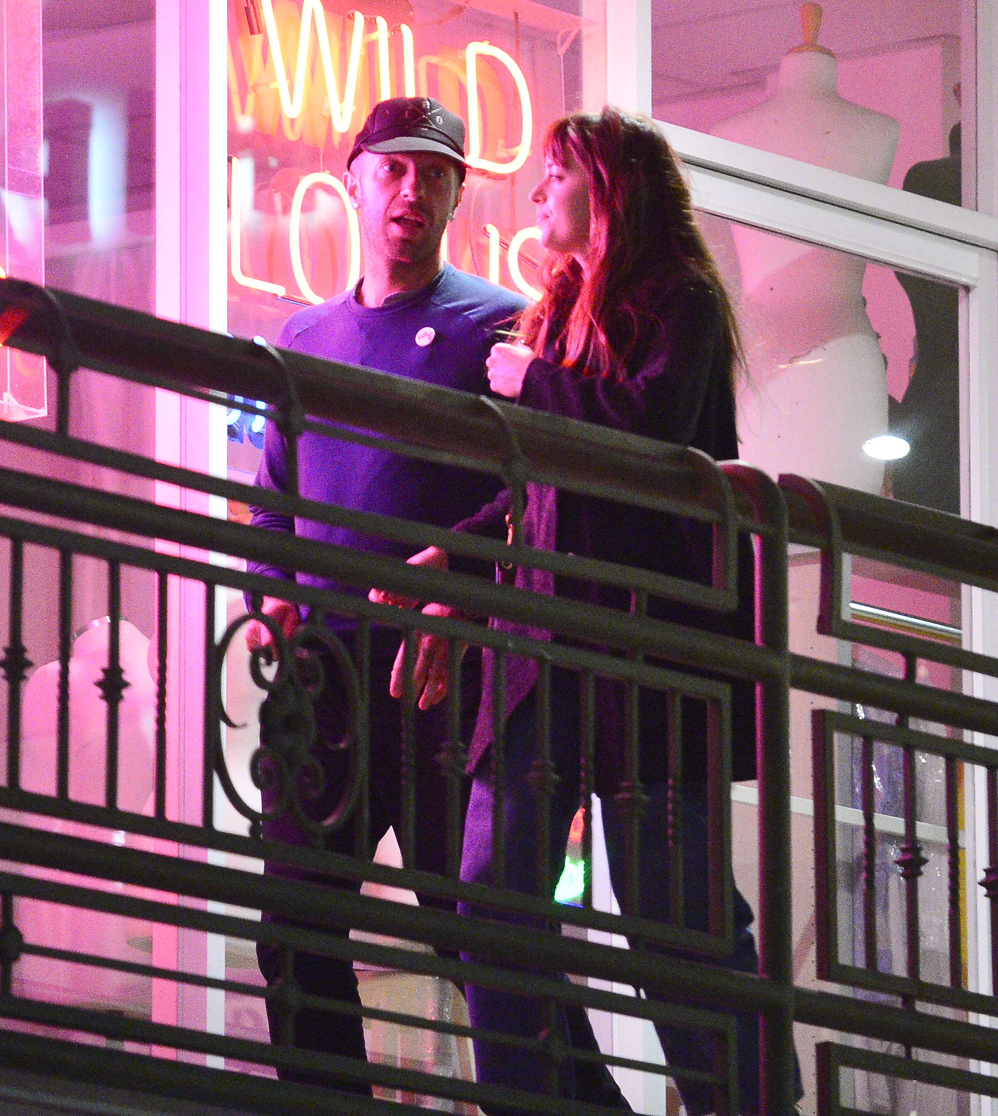 Dakota Johnson and Chris Martin at night. 