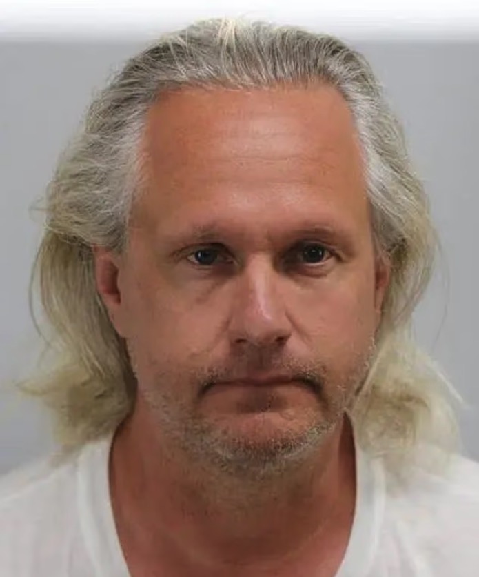Mugshot of a man with long gray hair.