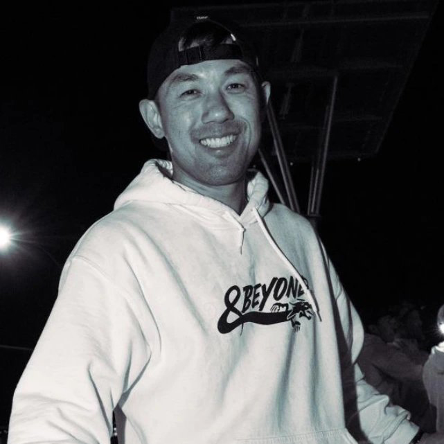 Black and white photo of Alex Chiu wearing a hoodie.