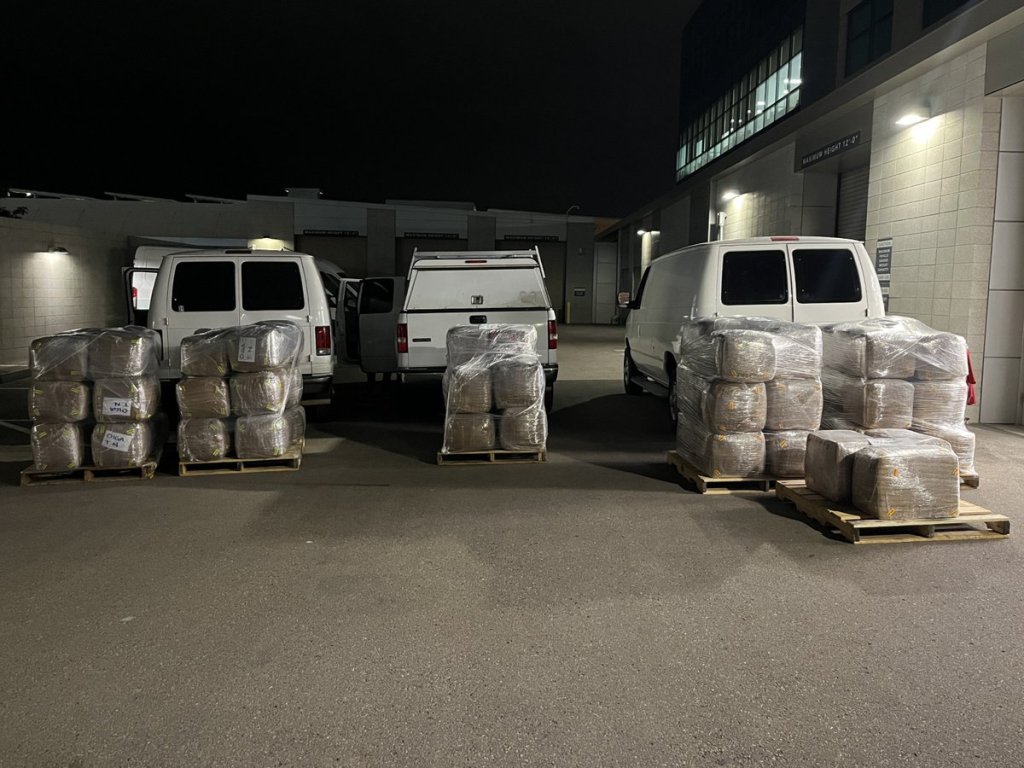 Three vans with pallets of seized methamphetamine.