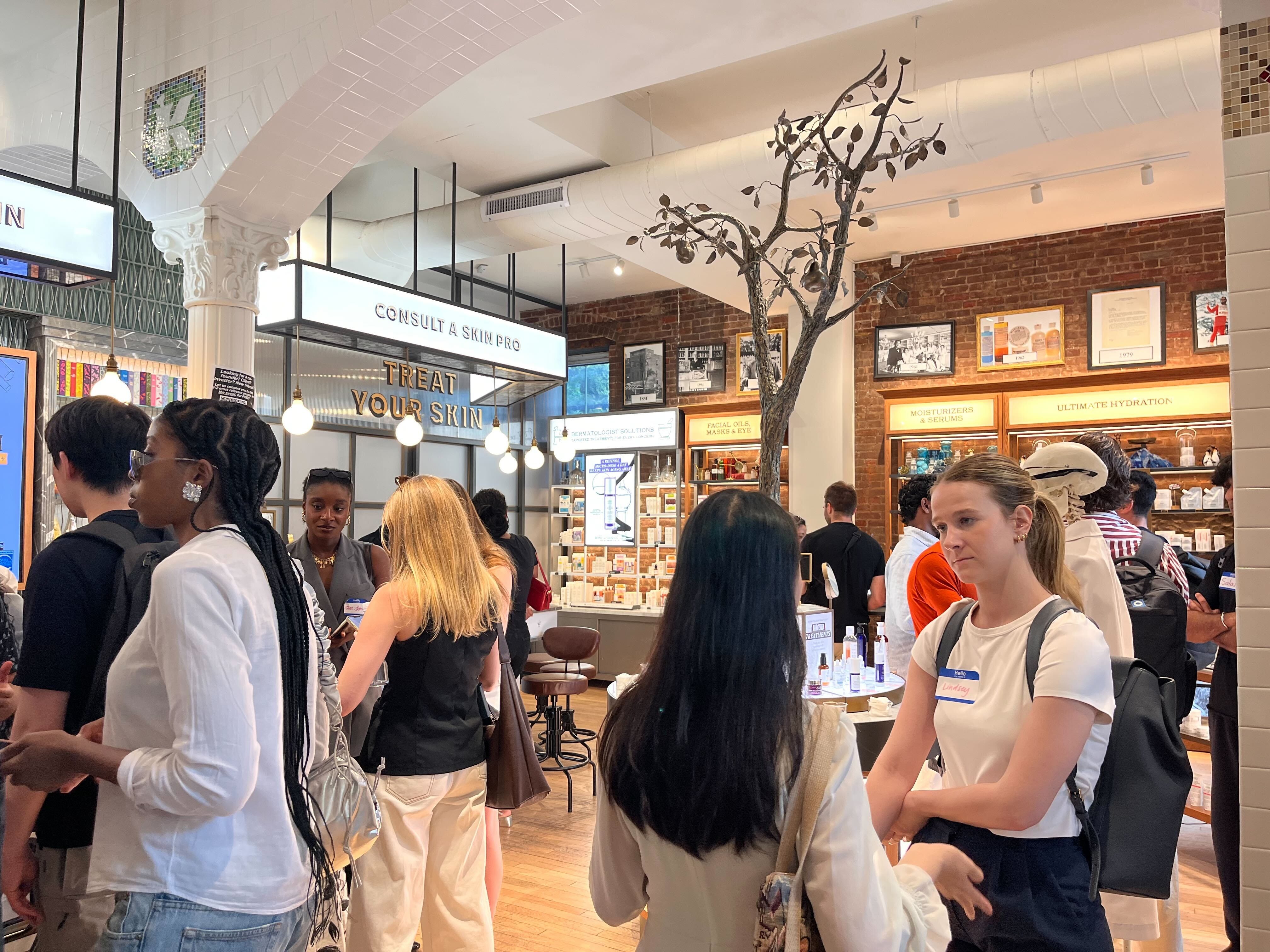 Attendees mingle at a mixer for GenZ founders at a Kiehls skincare store in Manhattan's East Village neighborhood.